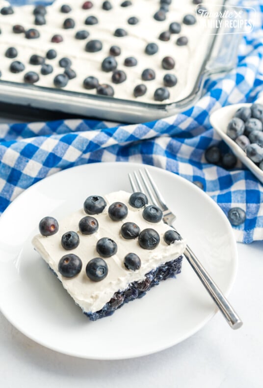 Blueberry Jello Salad topped with fresh blueberries in a glass baking dish