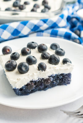Blueberry Jello Salad topped with fresh blueberries in a glass baking dish