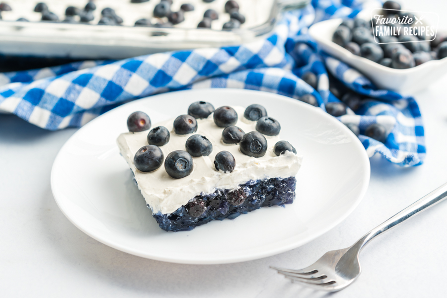 Blueberry Jello Salad topped with fresh blueberries in a glass baking dish.