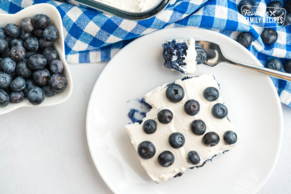 Blueberry Jello Salad topped with fresh blueberries in a glass baking dish