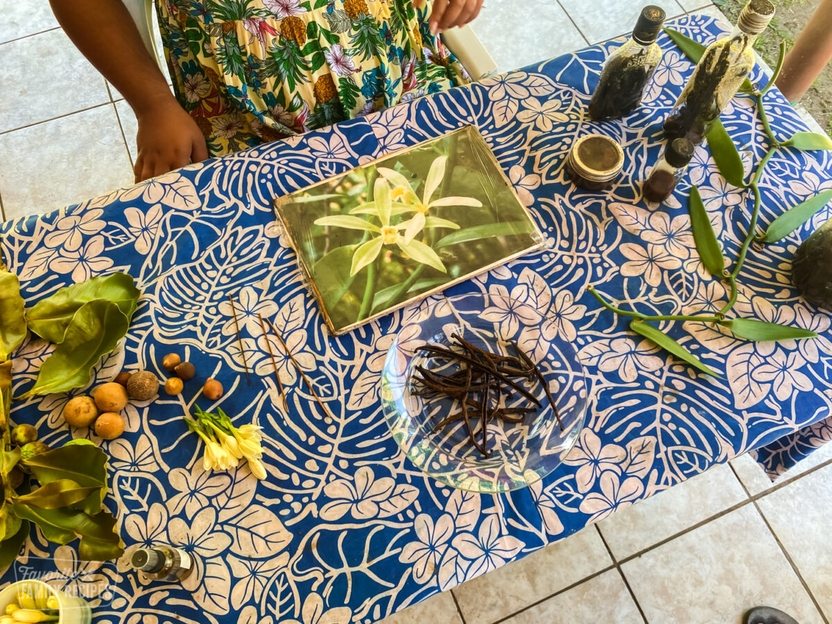 A table in Tahiti with Tahitian vanilla beans and other ingredients to make vanilla extract.
