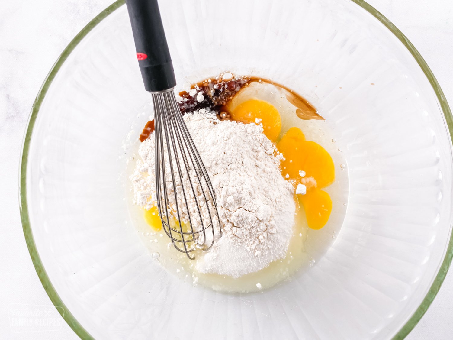 Eggs, flour, sugar, and vanilla in a bowl to make Instant Pot chocolate lava cake