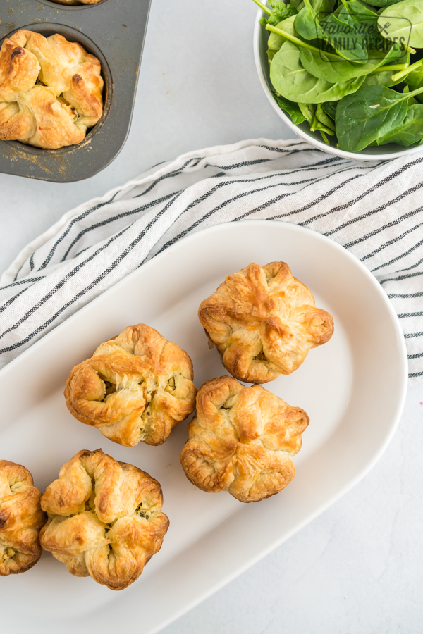 Four Spinach Puffs on a white plate.