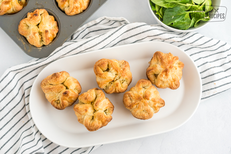 Five Spinach Puffs on a white plate.