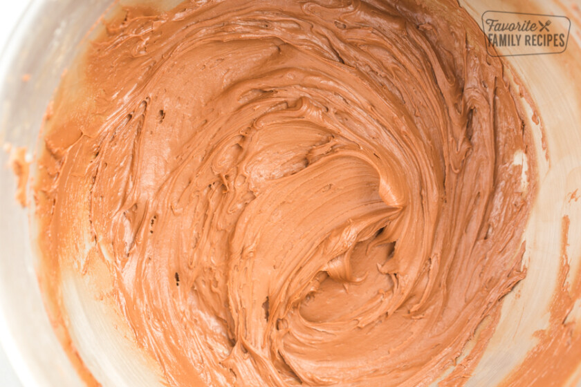 Chocolate Buttercream Frosting in a silver mixing bowl