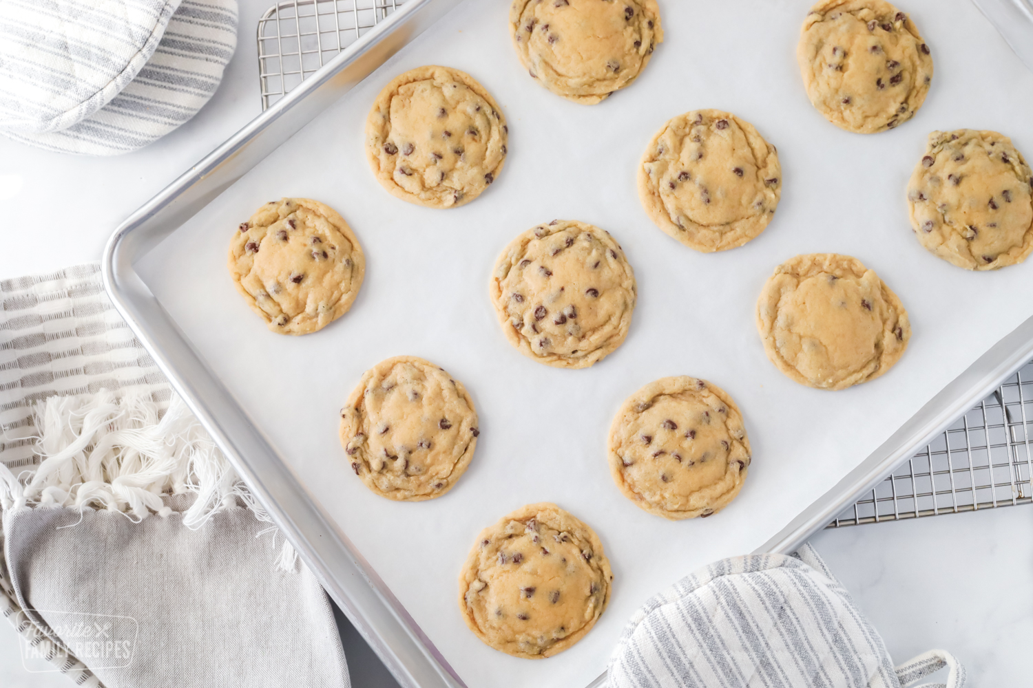 Chewy chocolate chip cookies on a baking sheet with parchment paper