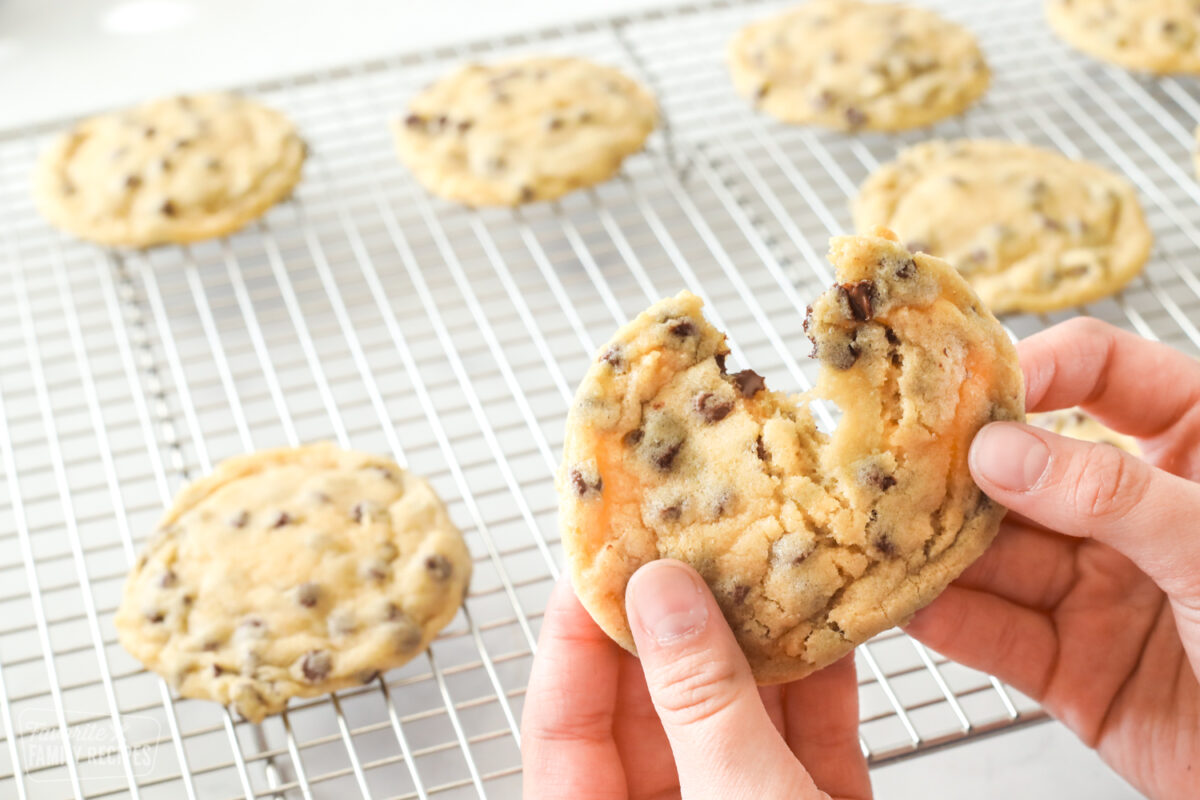 Close up of a chocolate chip cookie being pulled apart to show chewy texture