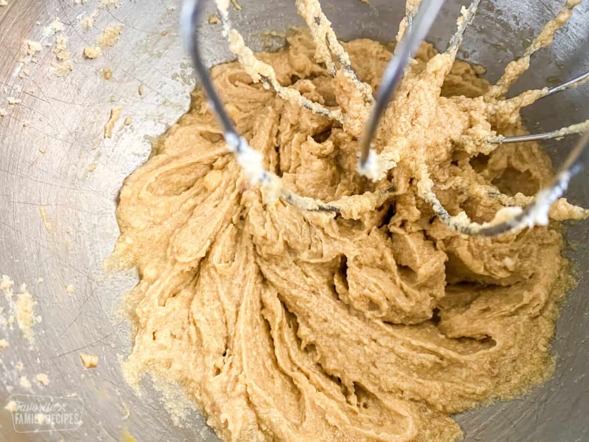 Sugar, Eggs, and Butter creamed together in a mixing bowl to make chocolate chip cookies