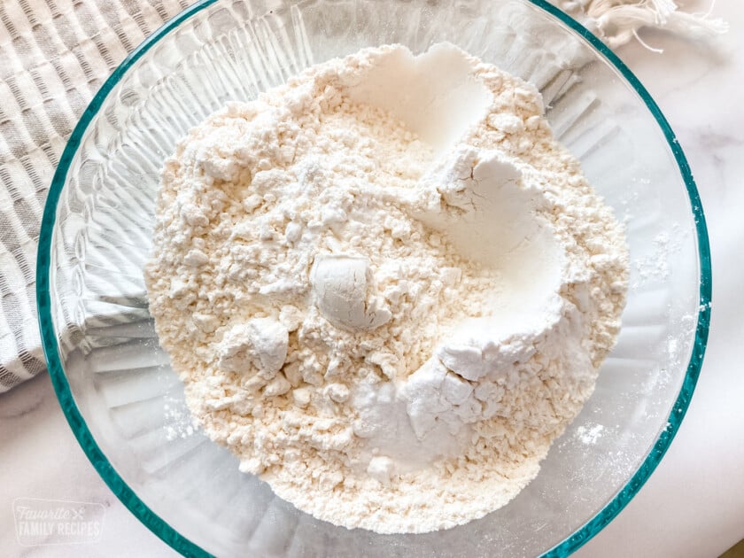 Flour, baking powder, baking soda, and salt in a mixing bowl to make chocolate chip cookies