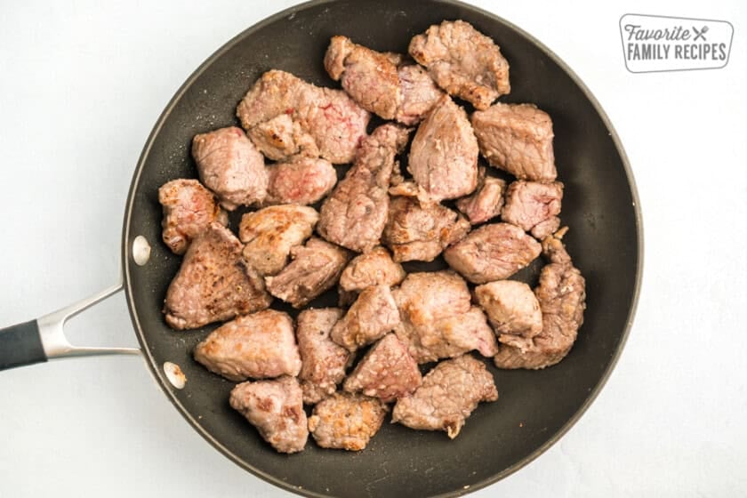 Browned beef stew meat in a skillet