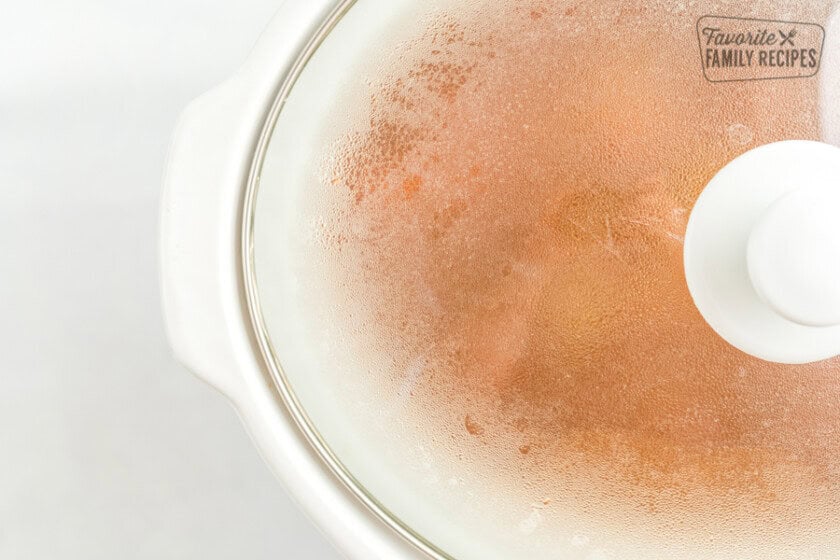 Stew cooking in a crock pot with the lid on