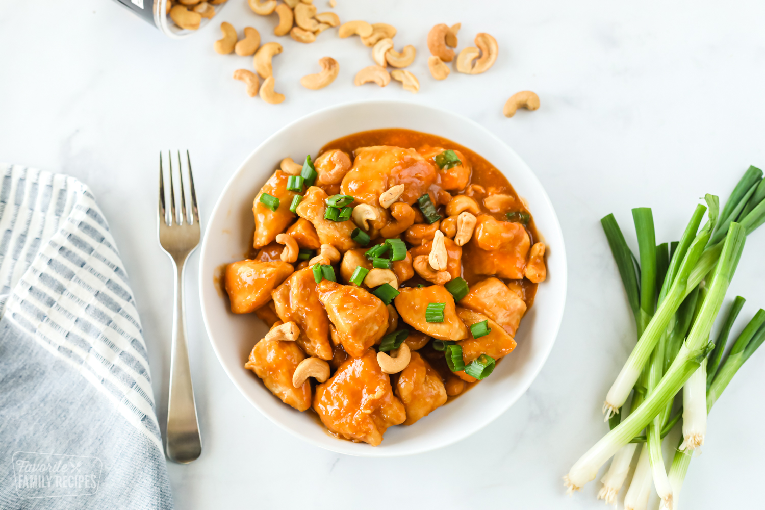 Crock pot chicken in a light sauce made with cashews and green onion