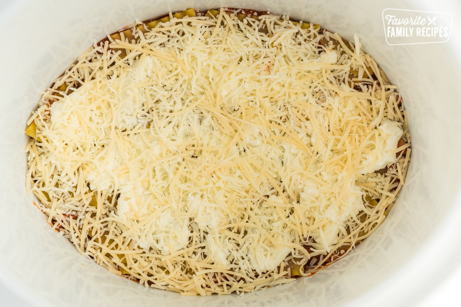 Meat sauce, lasagna noodles, and cheese layered in a crock pot