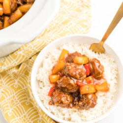 A bowl of rice topped with sweet and sour meatballs