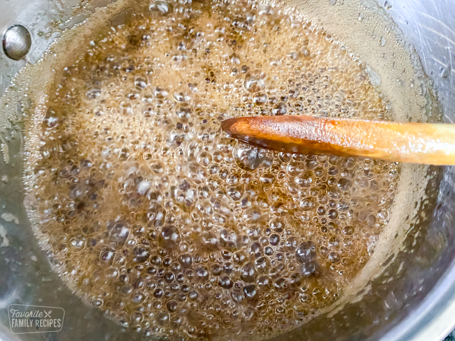 Syrup made with brown sugar, water, and maple extract simmering in a saucepan