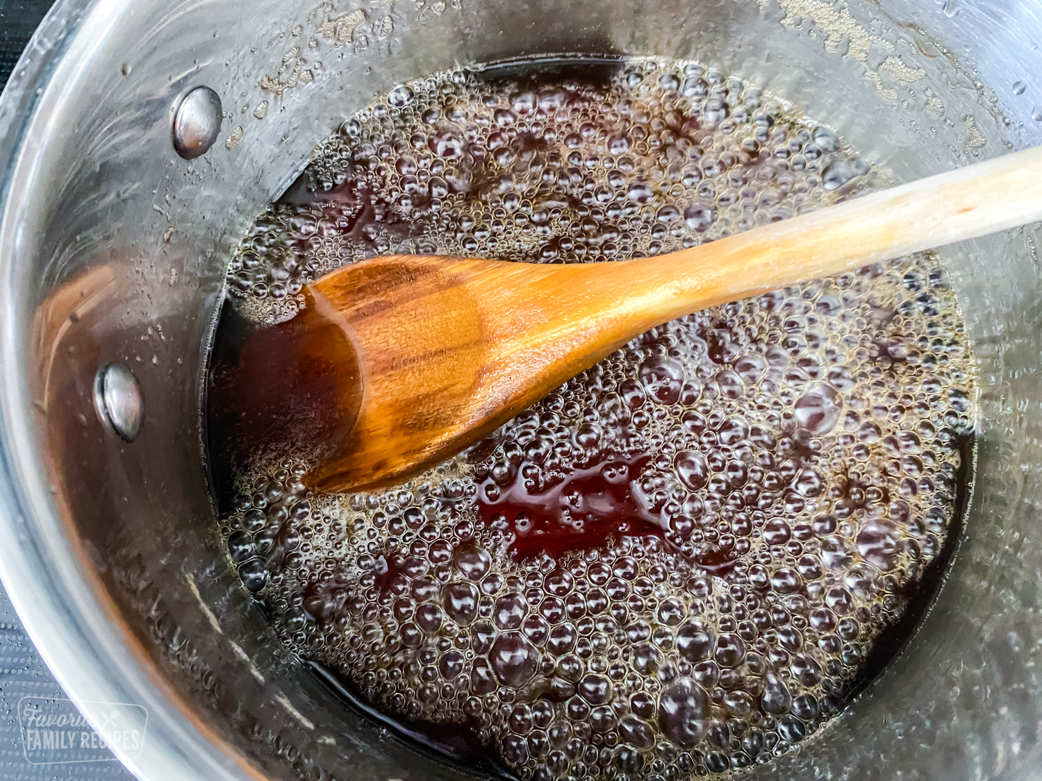 Brown sugar, sugar, maple extract and water that has been simmered in a saucepan to make maple syrup