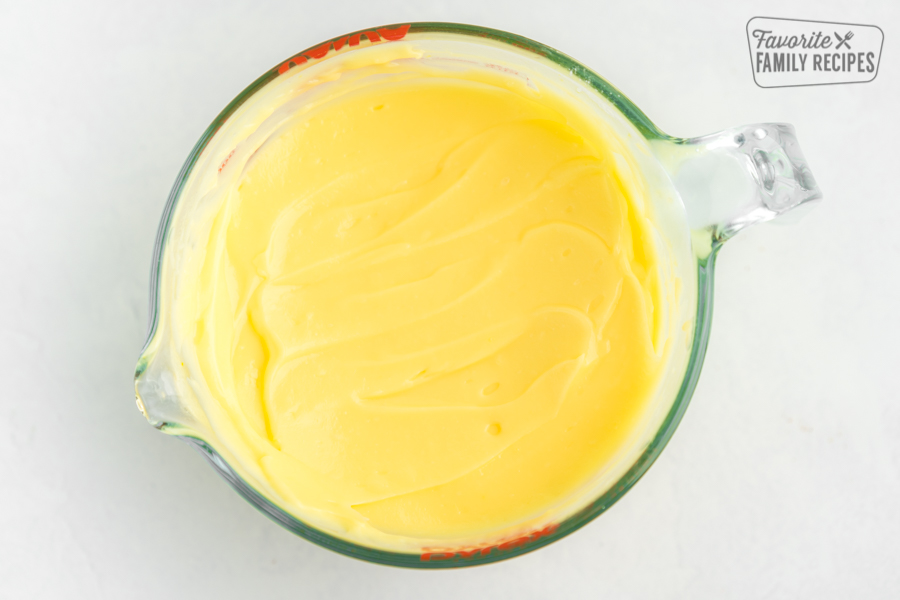 Lemon pudding in a glass measuring cup