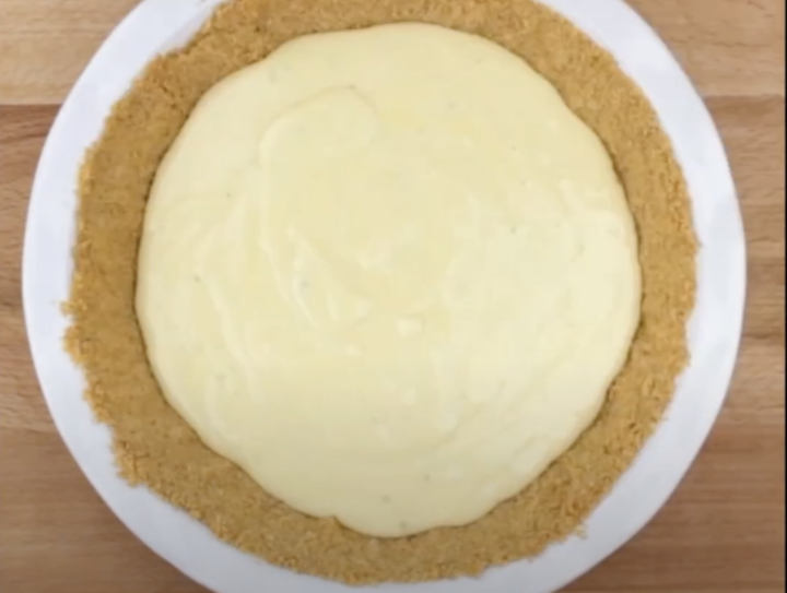 Key lime pie filling that has been poured into a graham cracker crust to make key lime pie recipe