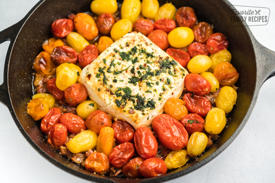 Heirloom cherry tomatoes and a block of feta baked in a cast iron skillet