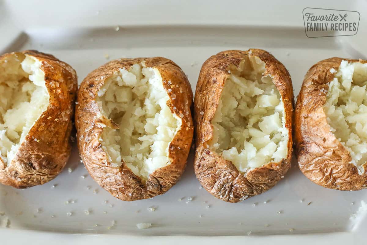Baked potatoes that have been opened and mashed inside.
