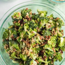 A photo of broccoli salad in a glass bowl.