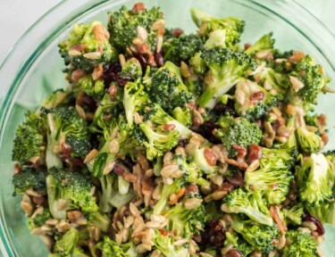 A photo of broccoli salad in a glass bowl.