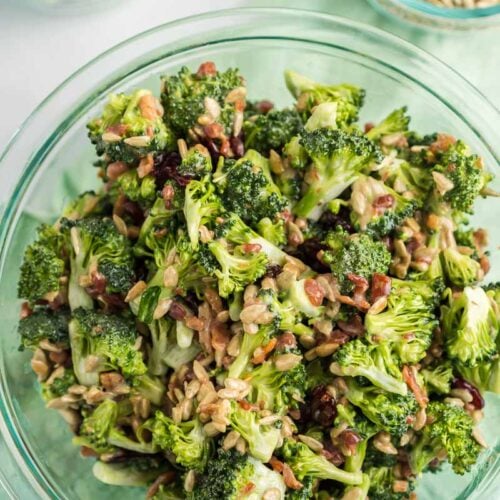 A photo of broccoli salad in a glass bowl.