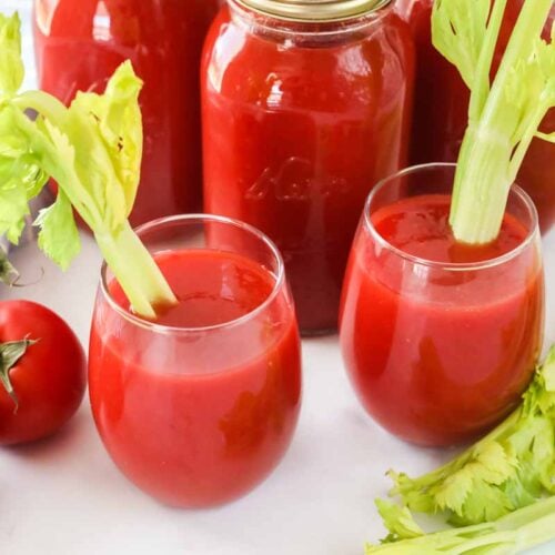 Two glasses of tomato juice and three quart jars of canned tomato juice