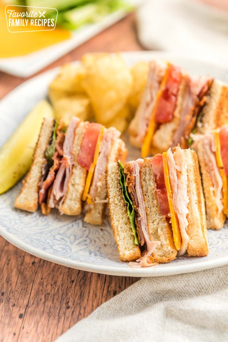 Quarters of a club sandwich served on a lunch plate