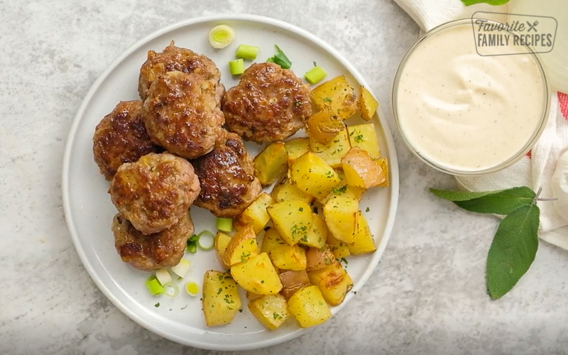 Danish Meatballs on a plate with potatoes and a side of gravy