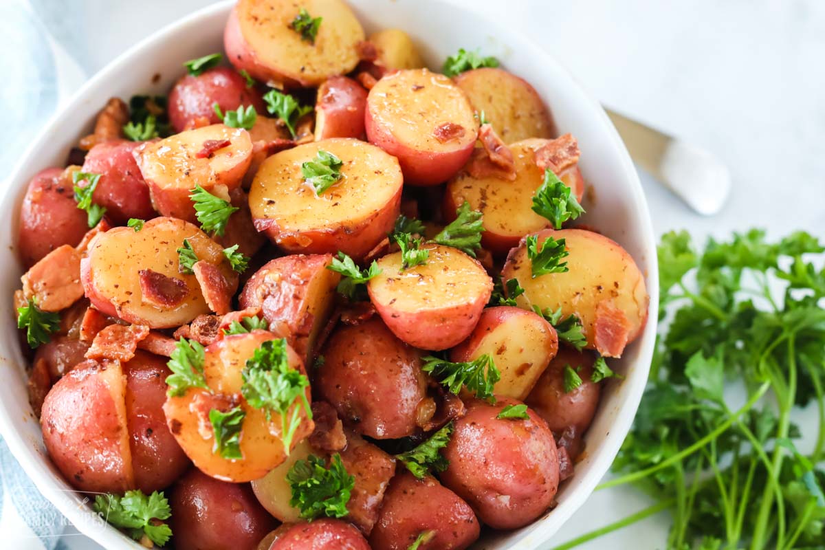 A close up of German potato salad made with mini red potatoes and a bacon vinaigrette.