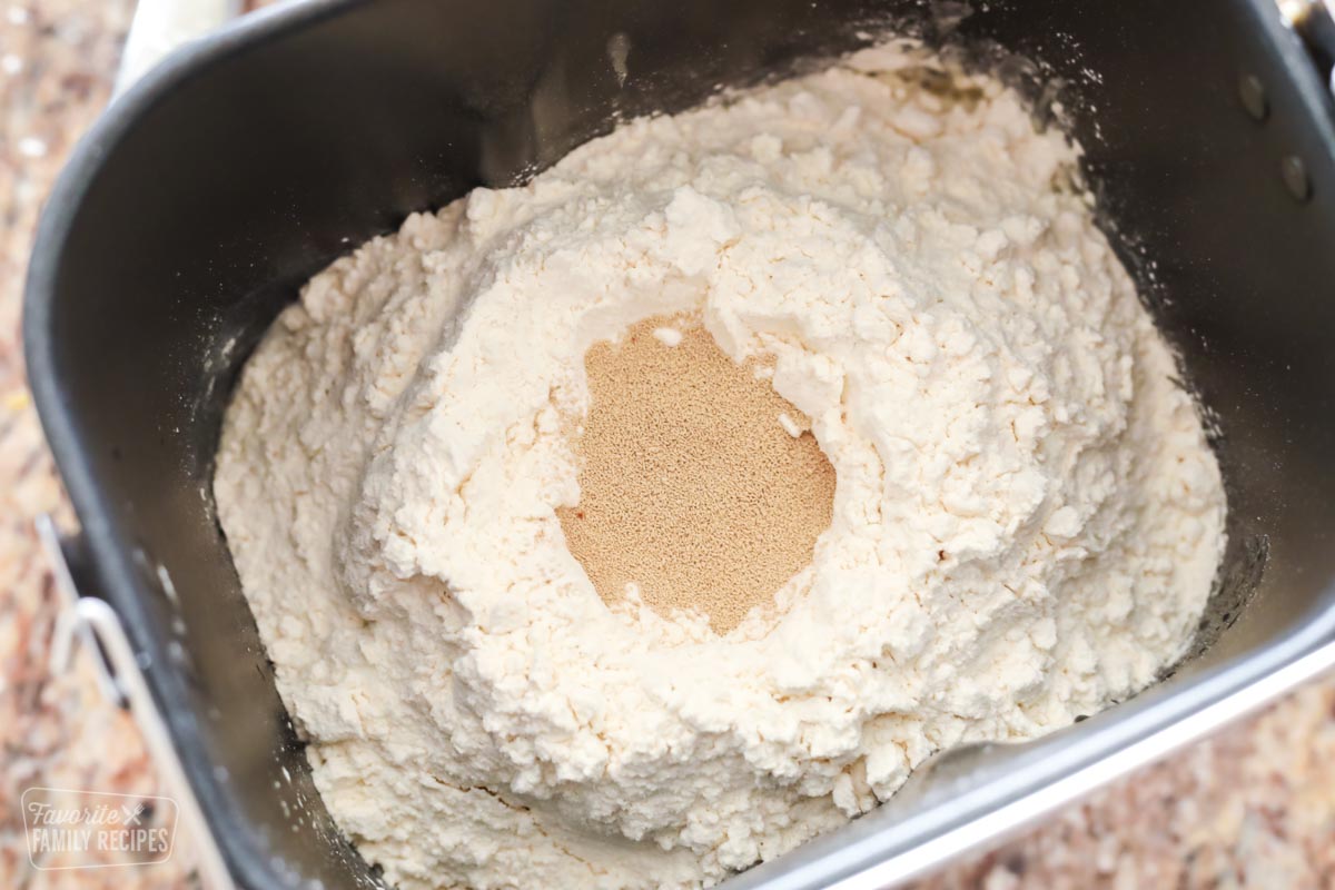 Flour and yeast in a bread machine to make burger buns