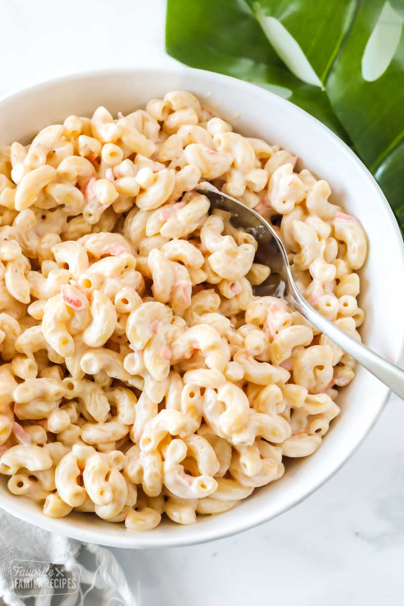 Hawaiian macaroni salad in a large bowl with a serving spoon.