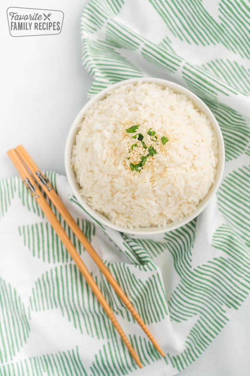A bowl of rice with chopsticks