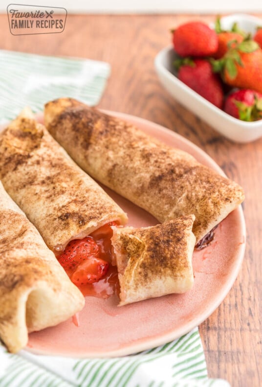 Strawberry empanadas on a pink plate.