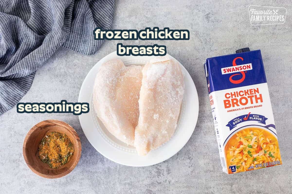 Ingredients needed to cook frozen chicken breasts in instant pot: frozen chicken, chicken broth, seasonings.