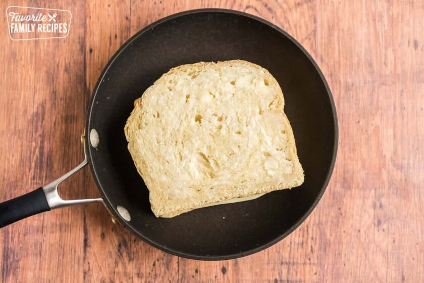 An uncooked grilled cheese sandwich in a pan