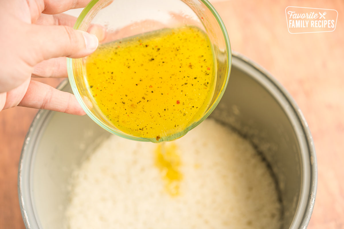 Lemon sauce being poured onto rice