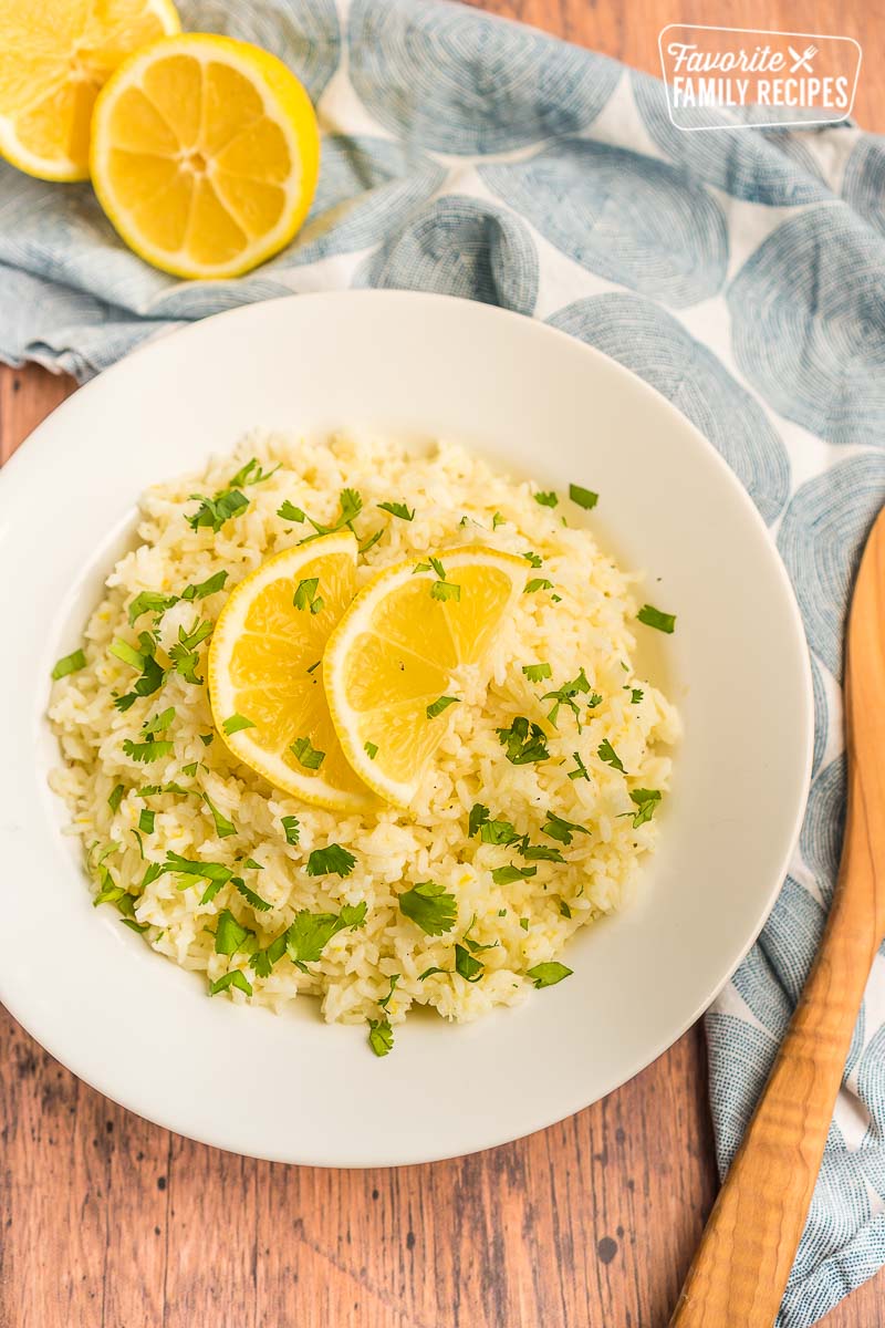 Lemon rice in a white bowl topped with lemon slices