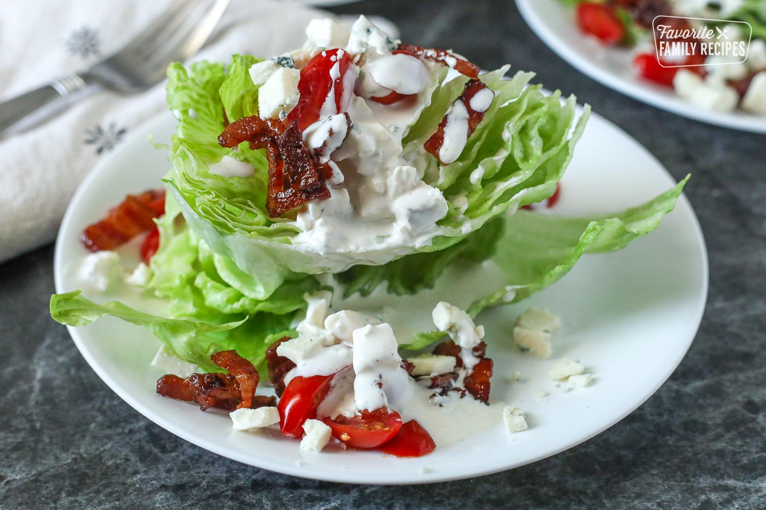 Wedge Salad with bacon, tomatoes, and blue cheese.