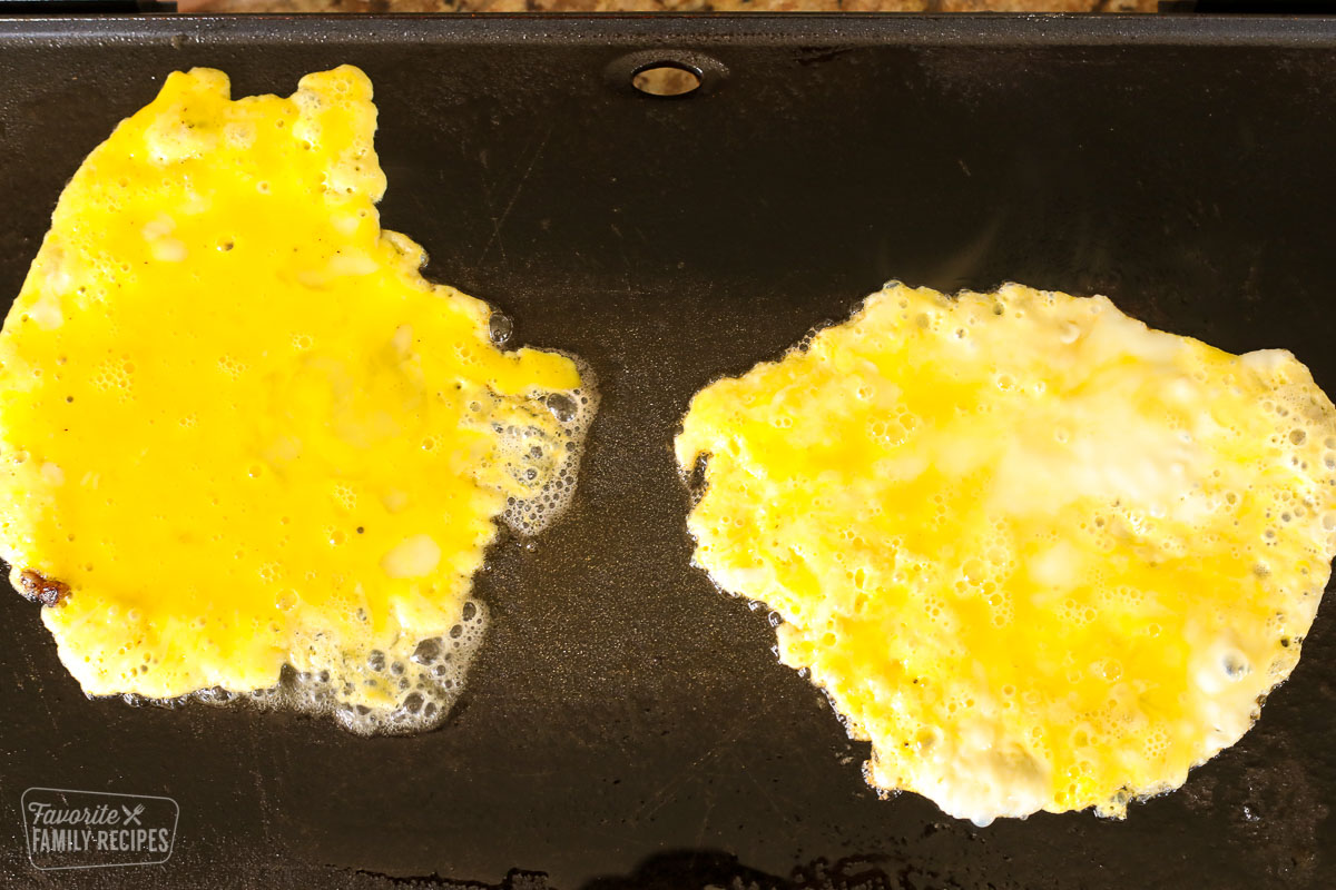 Scrambled eggs on a griddle.
