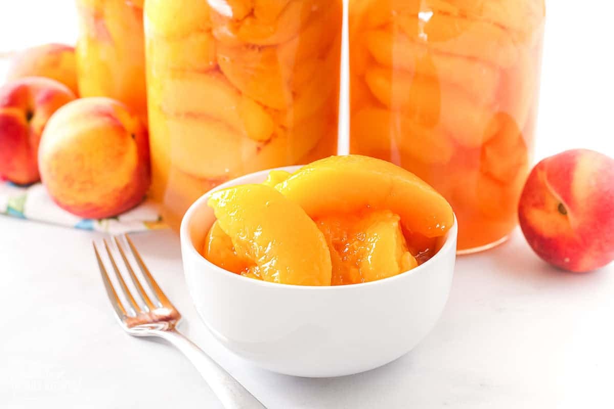 A bowl of sliced, canned peaches