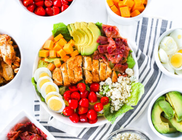 A bowl of salad with Cobb salad toppings.