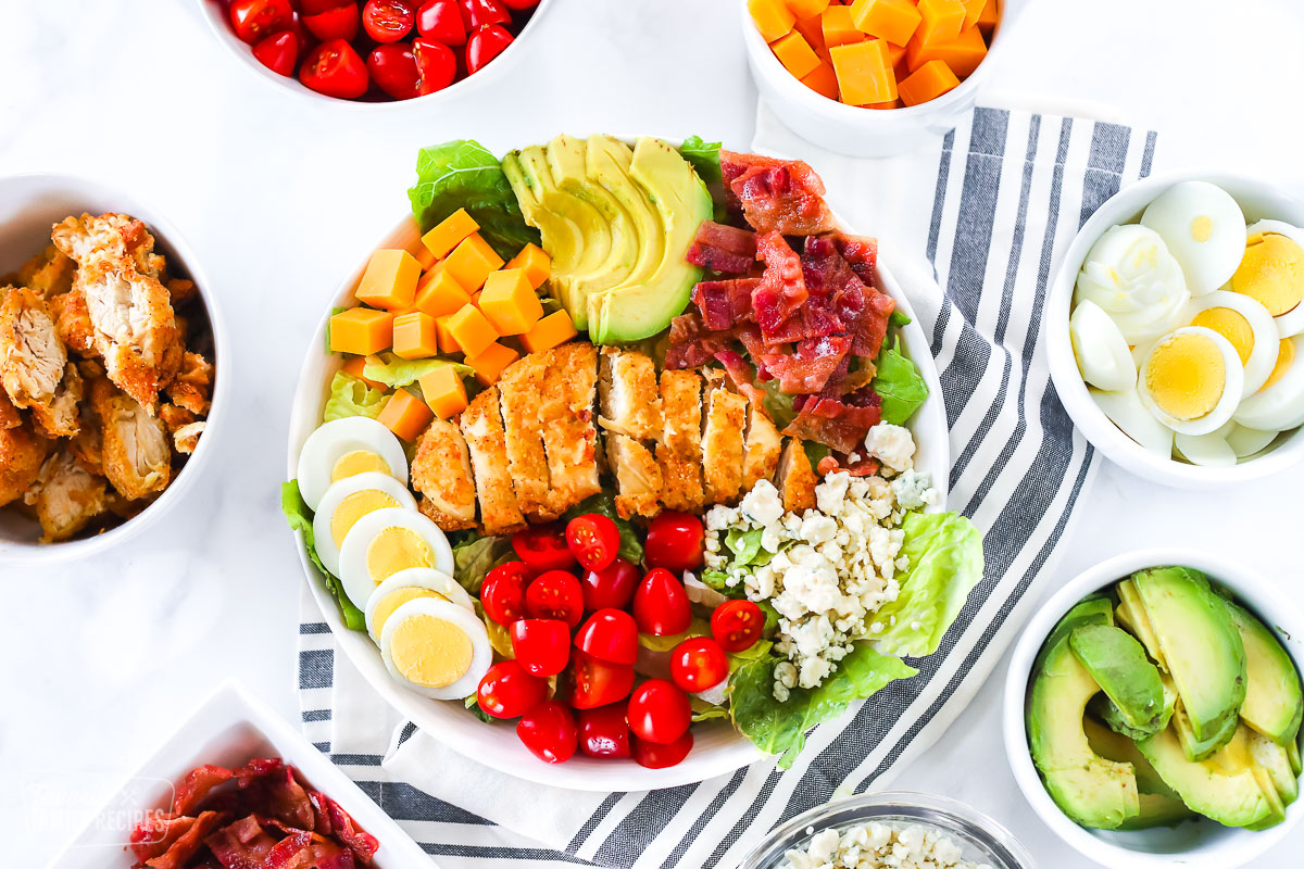 A bowl of salad with Cobb salad toppings.