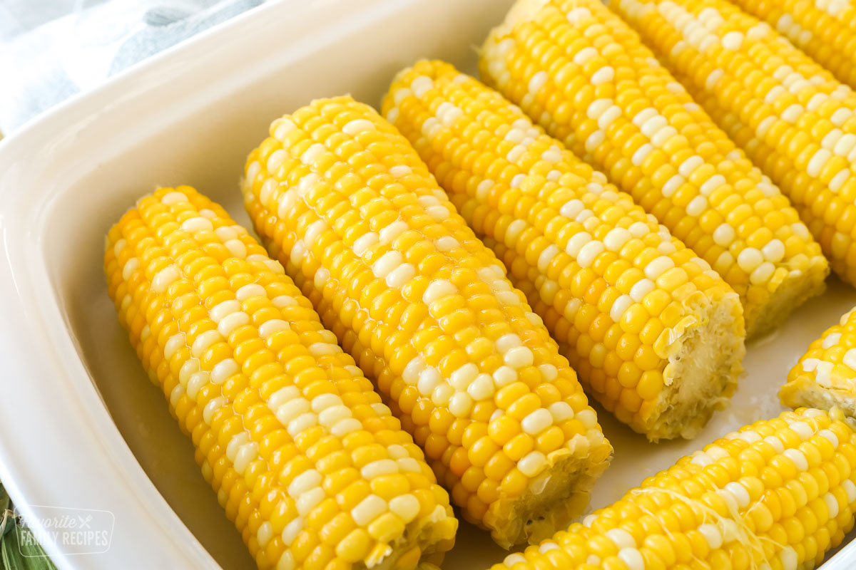 Sweet corn in a white baking dish with butter