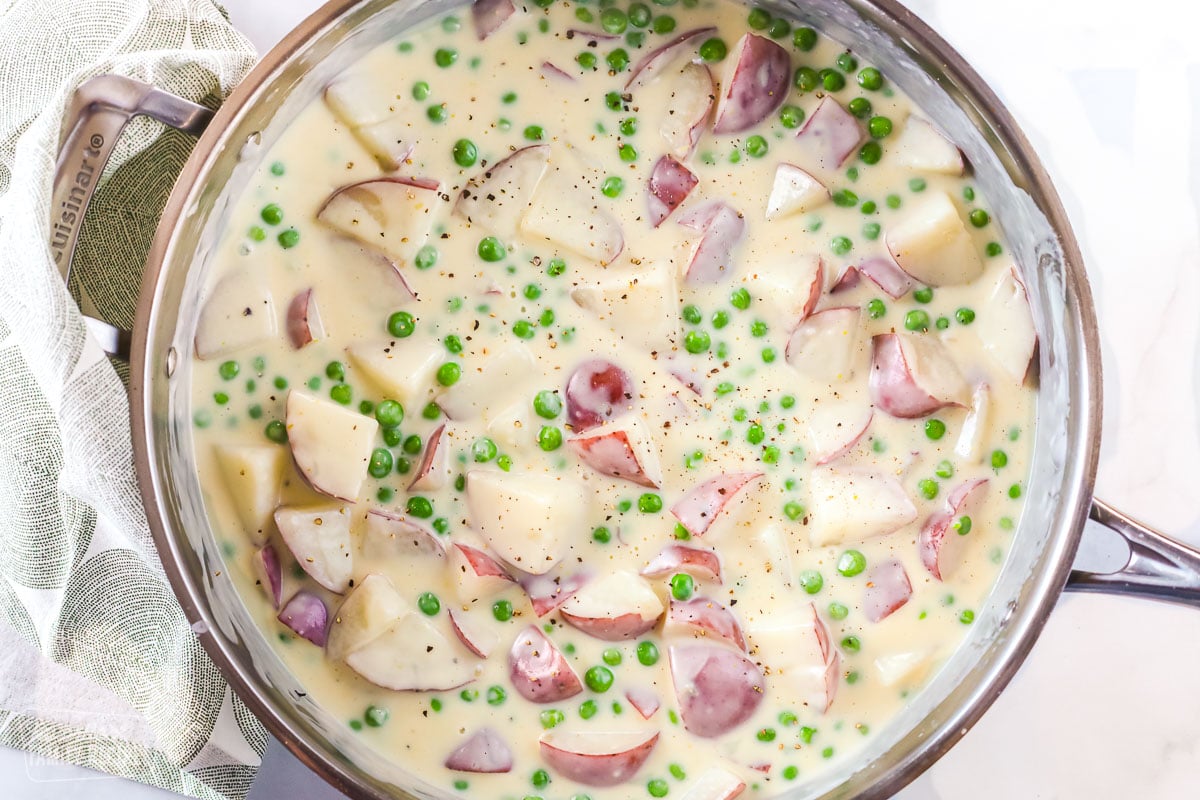 Creamy peas and potatoes in a skillet