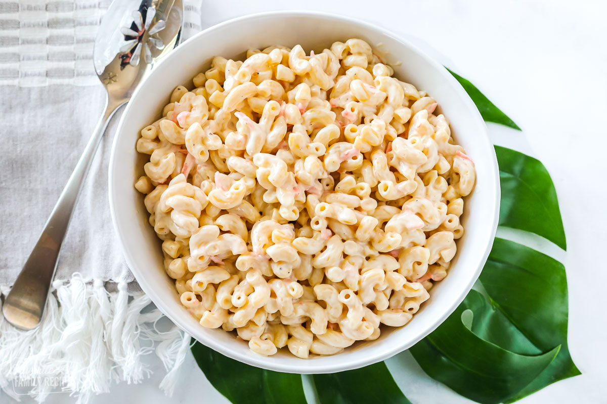 Top view of a serving bowl of Hawaiian macaroni salad made with macaroni noodles, mayo, and shredded carrot.