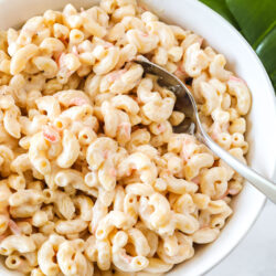 Hawaiian macaroni salad in a large bowl with a serving spoon.