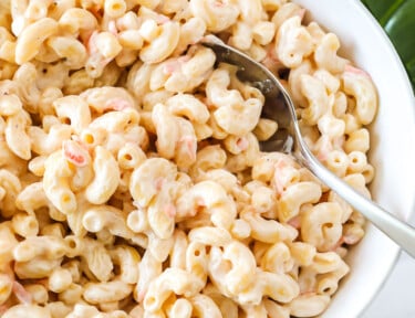 Hawaiian macaroni salad in a large bowl with a serving spoon.