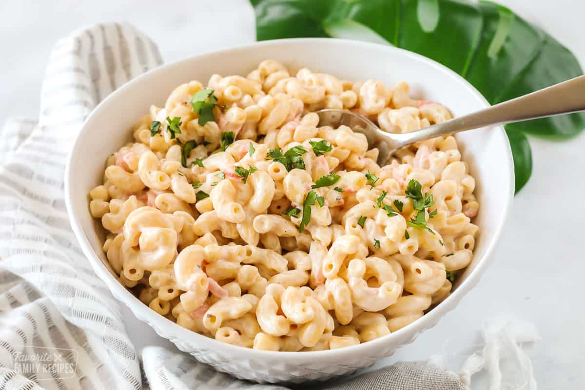 Hawaiian macaroni salad made with macaroni, carrots, and mayo and garnished with parsley.